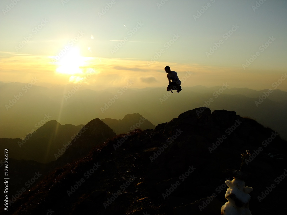 Man jumping up on the Top of the Nebelhorn Mountains in Germany Alps