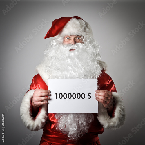 Santa Claus is holding a white paper in his hands. One million d