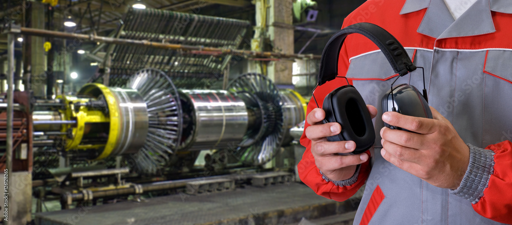 Worker with protective headphone Worker with protective headphone