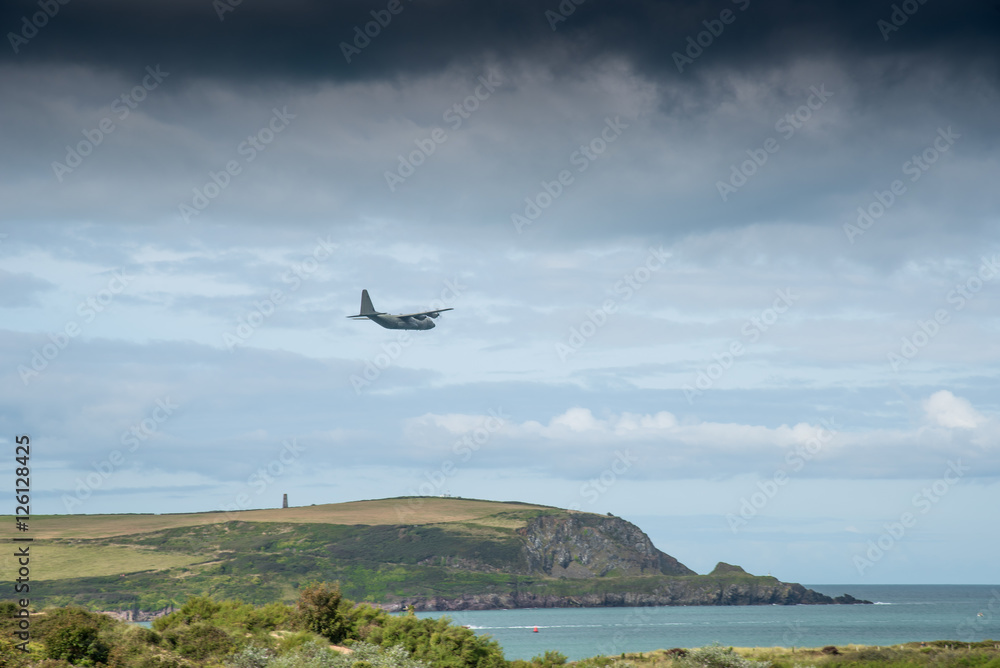 Camel estuary at Daymer Bay in Cornwall with a military transport plane in low-level flight. Camel estuary at Daymer Bay in Cornwall with a military transport plane in low-level flight.