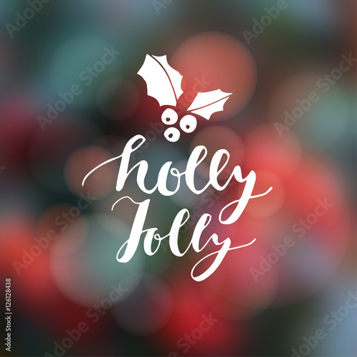 Christmas greeting card, invitation. Hand lettered text with holly icon. Festive modern blurred background with bokeh lights.