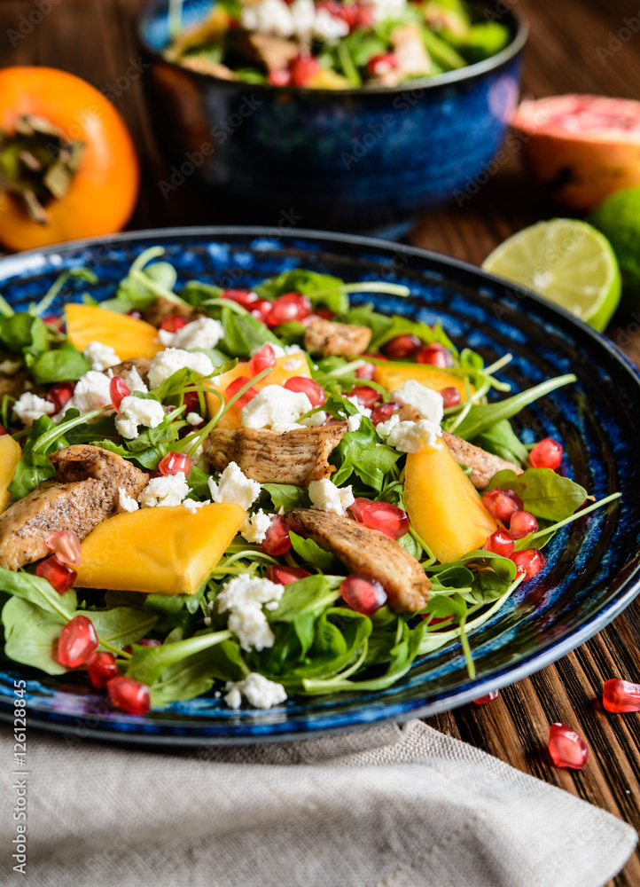Arugula salad with pomegranate, chicken meat, persimmons and Feta cheese