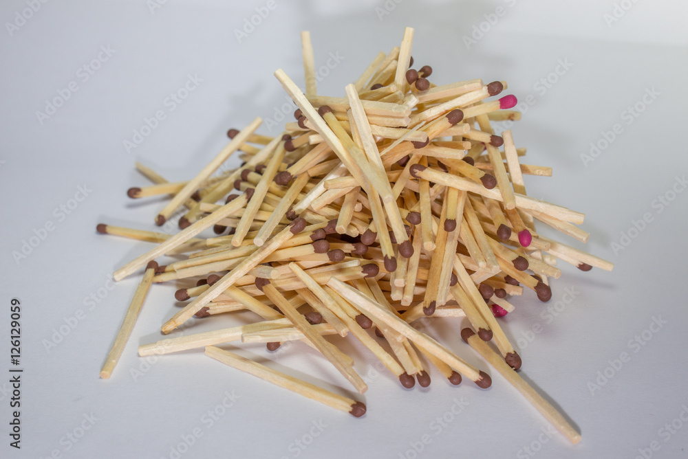 A pile of unburned matchsticks on white background A pile of unburned matchsticks on white background
