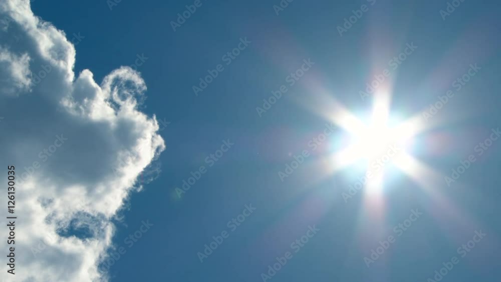 Large cloud clears leaving bright and sunny blue sky with jet contrail traveling through frame, time lapse. Large cloud clears leaving bright and sunny blue sky with jet contrail traveling through frame, time lapse.
