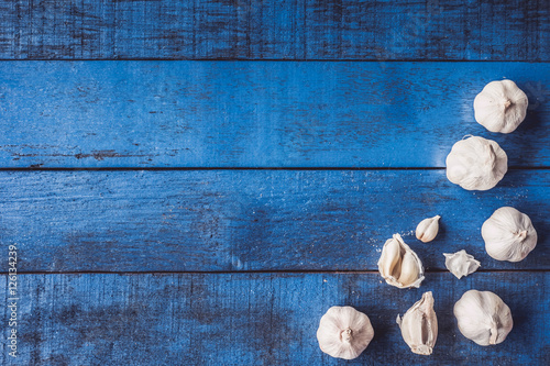 Top view of Garlic on blue wooden table background.