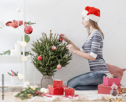 haappy girl with Christmas gifts indoor photo