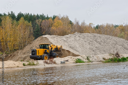 Earth-mover and a large pile of bank sand