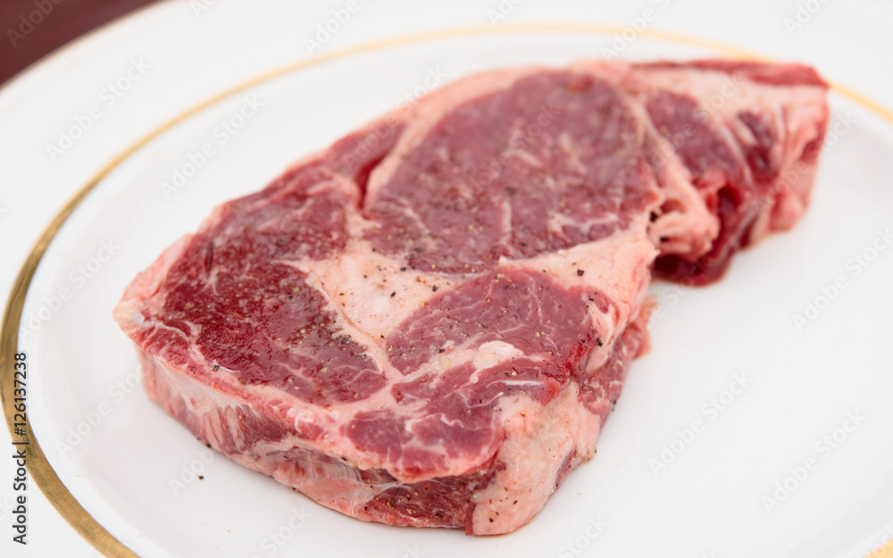 Rib eye steak in a rustic plate