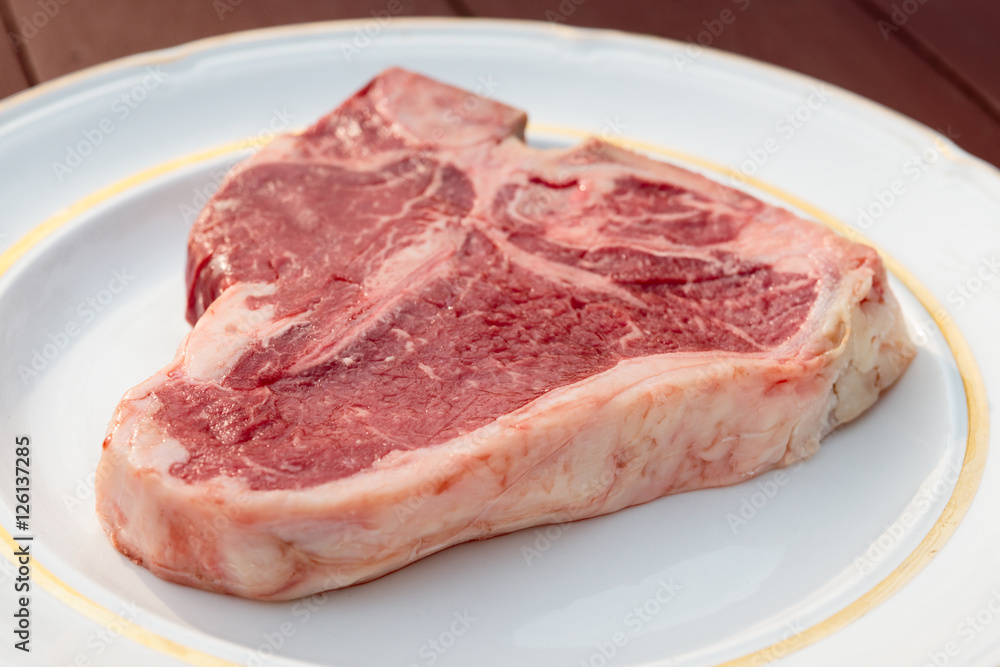 T-bone steak in a white plate