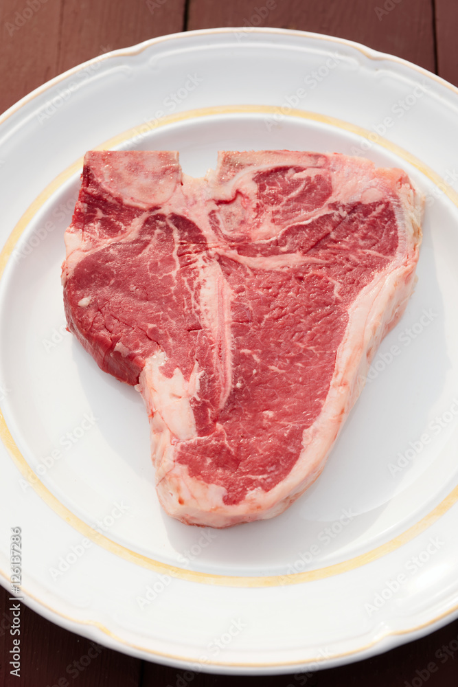 T-bone steak in a white  plate