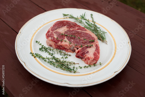 Rib eye steak in a rustic plate