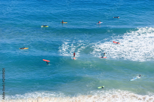 Astract shot from above. Surfers in the ocean