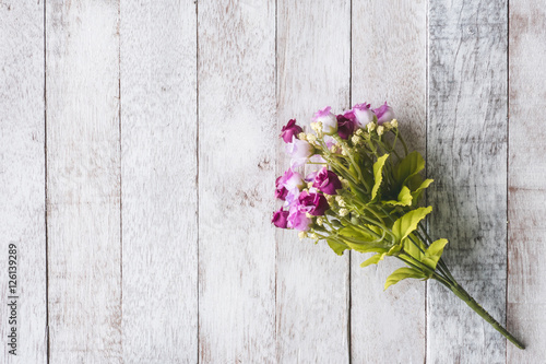 Top view of  Pink flowers on wooden table background.