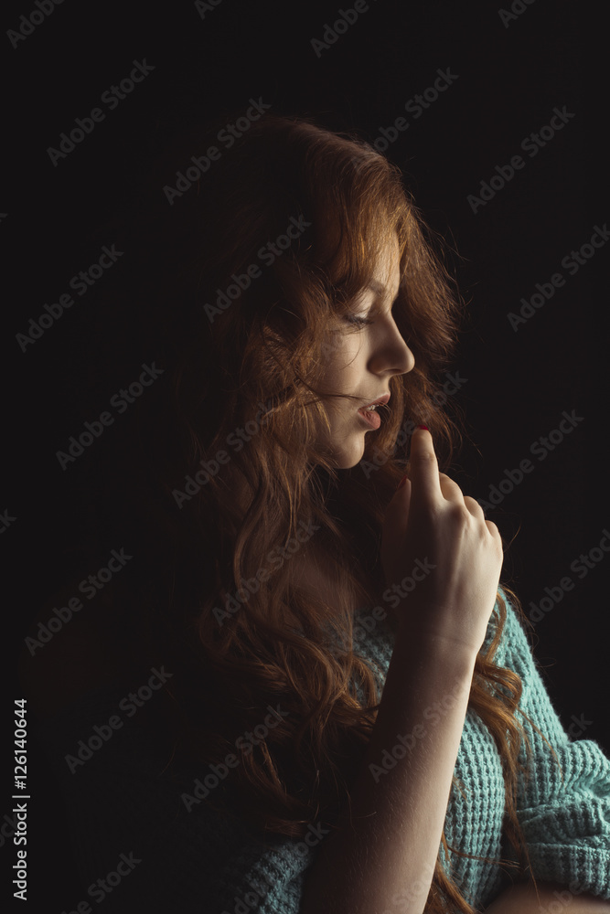 Glamorous model with curly hair in the shadows Glamorous model with curly hair in the shadows