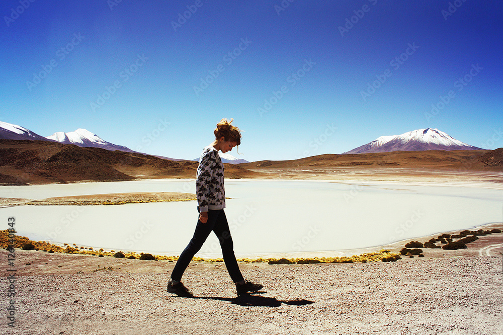 blond caucasian young woman at white lagoon in Bolivia
