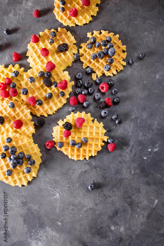 Belgian waffles with berries on the gray background