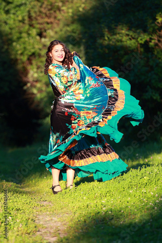 Beautiful gypsy girl in a traditional dance in the woods