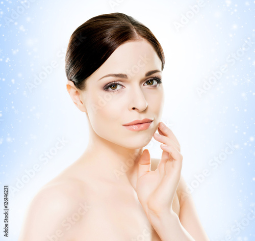 Portrait of a young woman in light makeup on the snow