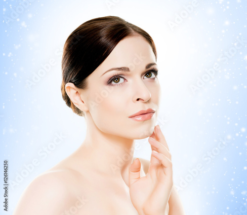 Portrait of a young woman in light makeup on the snow