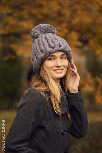 Beautiful young woman wearing merino wool pastel colors hat and
