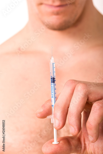 hand of a man hold a syringe injection needle isolated on a white background