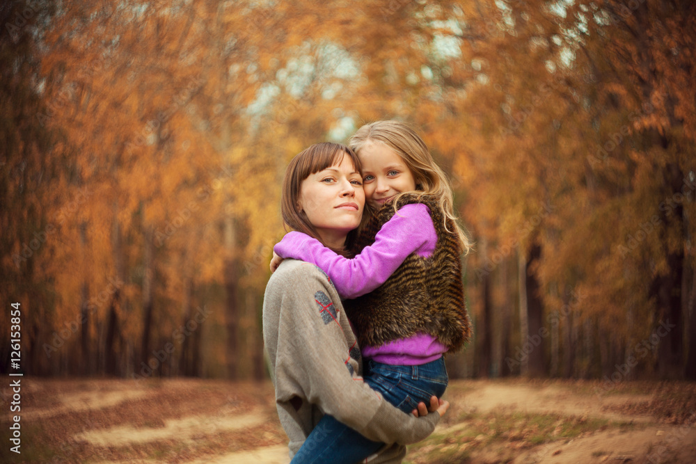 A woman holds her daughter in her arms A woman holds her daughter in her arms