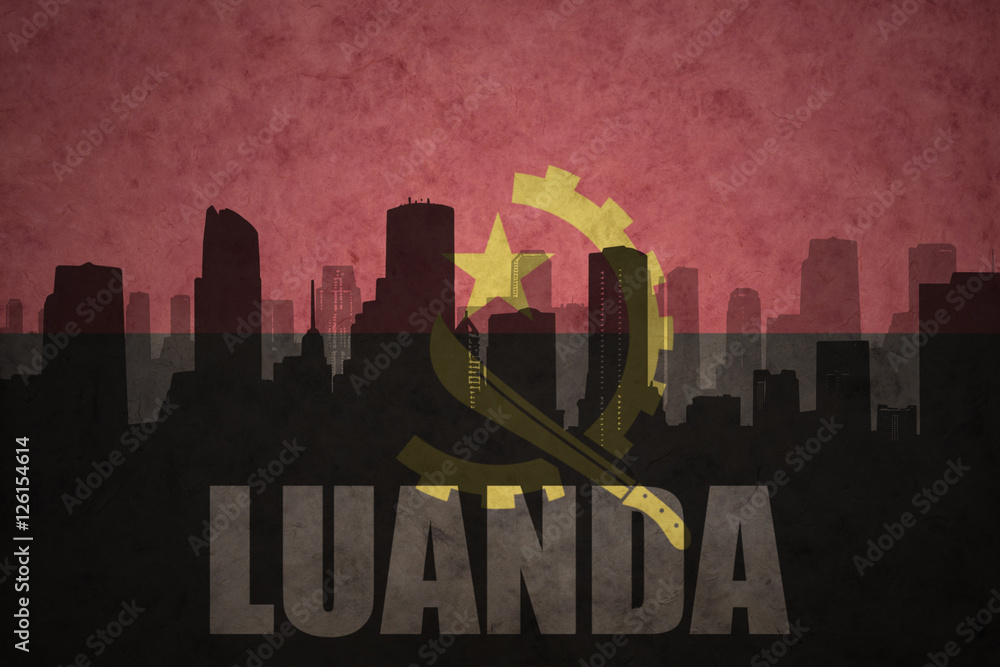 abstract silhouette of the city with text Luanda at the vintage angolan flag