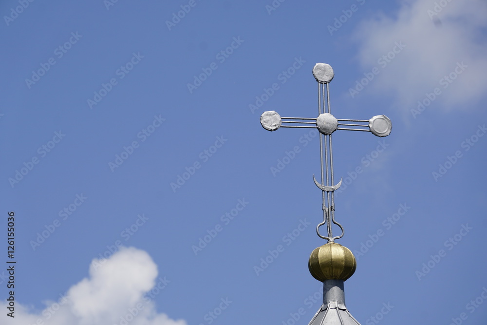 cross on top of a church in front of bright blue sky cross on top of a church in front of bright blue sky