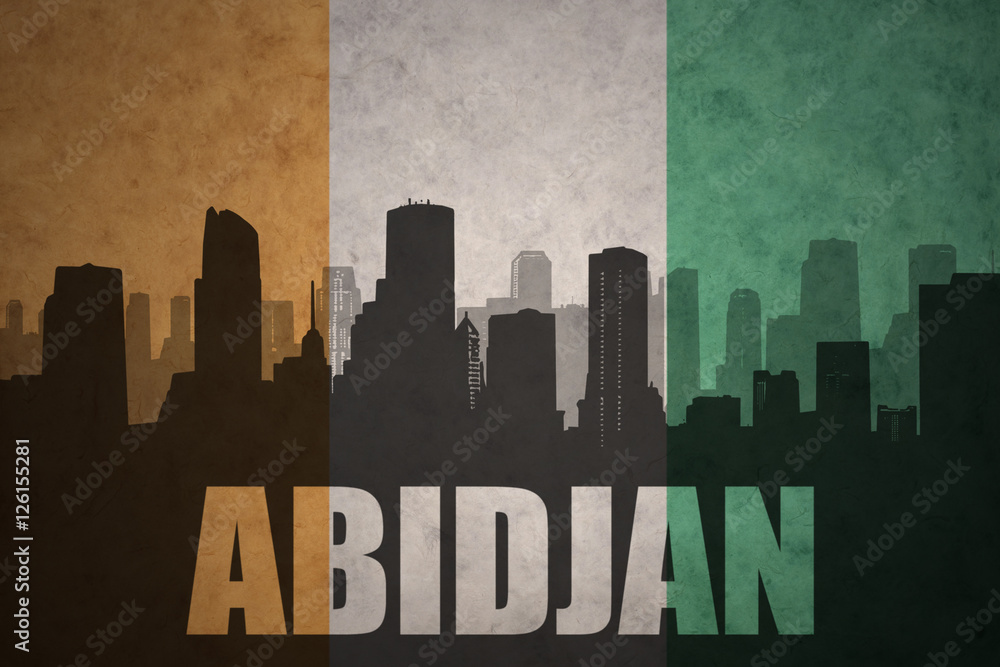 abstract silhouette of the city with text Abidjan at the vintage ivorian flag