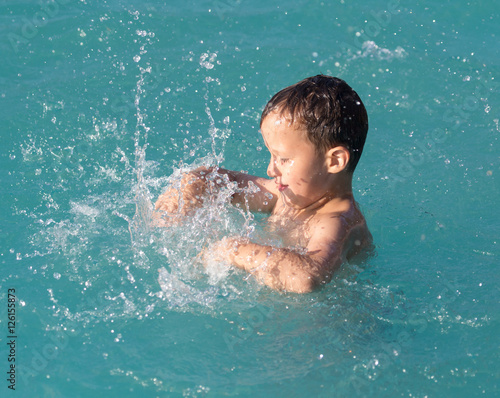 boy swims with a splash in the water park © schankz