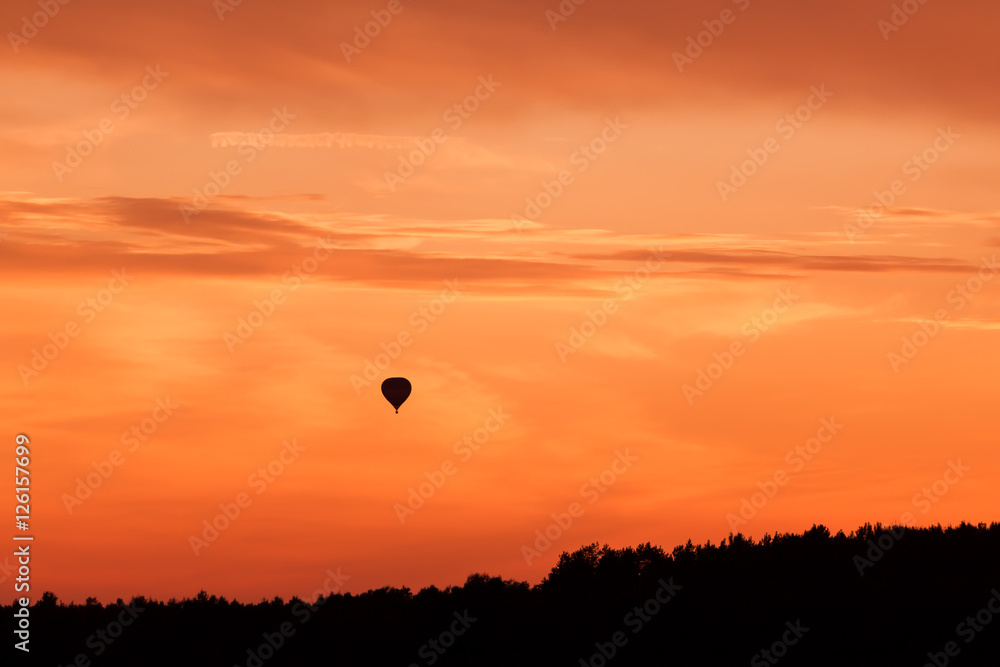 Hot air balloon flying at sunset sky Hot air balloon flying at sunset sky