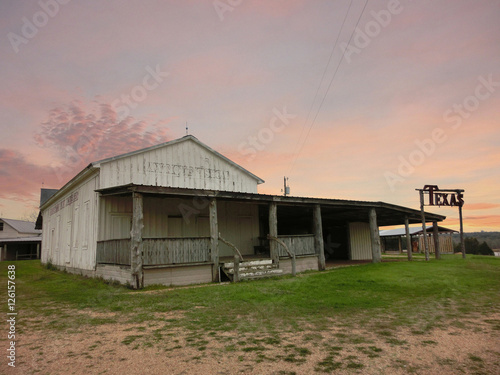 Texas rural farmhouse at dusk with pastel sky