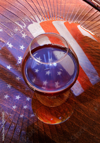 american flag reflected in the glass of whiskey