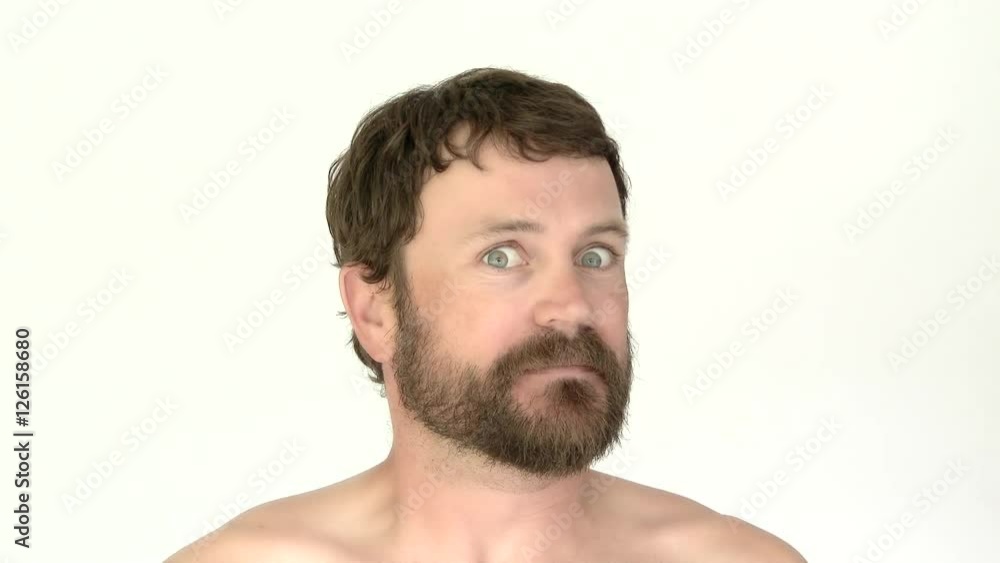 Model released man in studio with beard having scared and terrified reaction. Model released man in studio with beard having scared and terrified reaction.