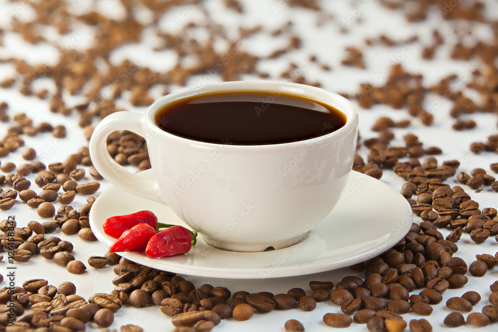 Obraz premium coffee in coffee cup with natural grains