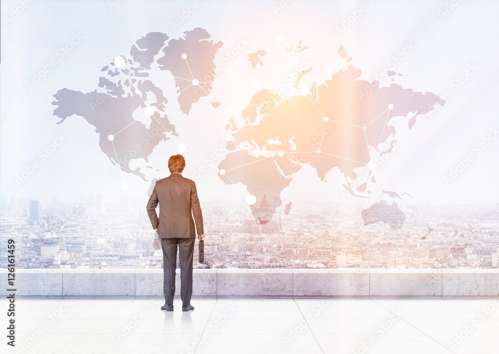 Man with suitcase is looking at world map Man with suitcase is looking at world map