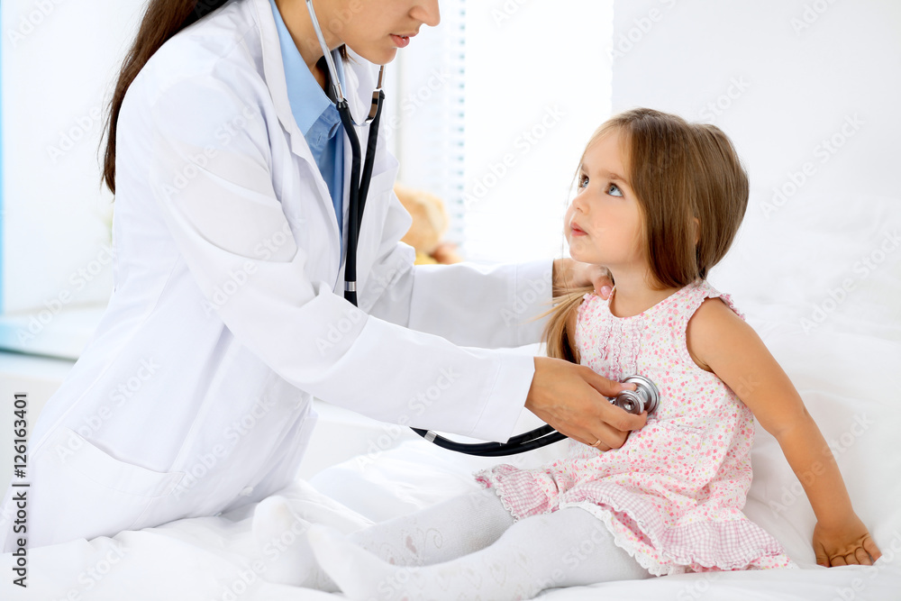 Doctor examining a little girl by stethoscope Doctor examining a little girl by stethoscope