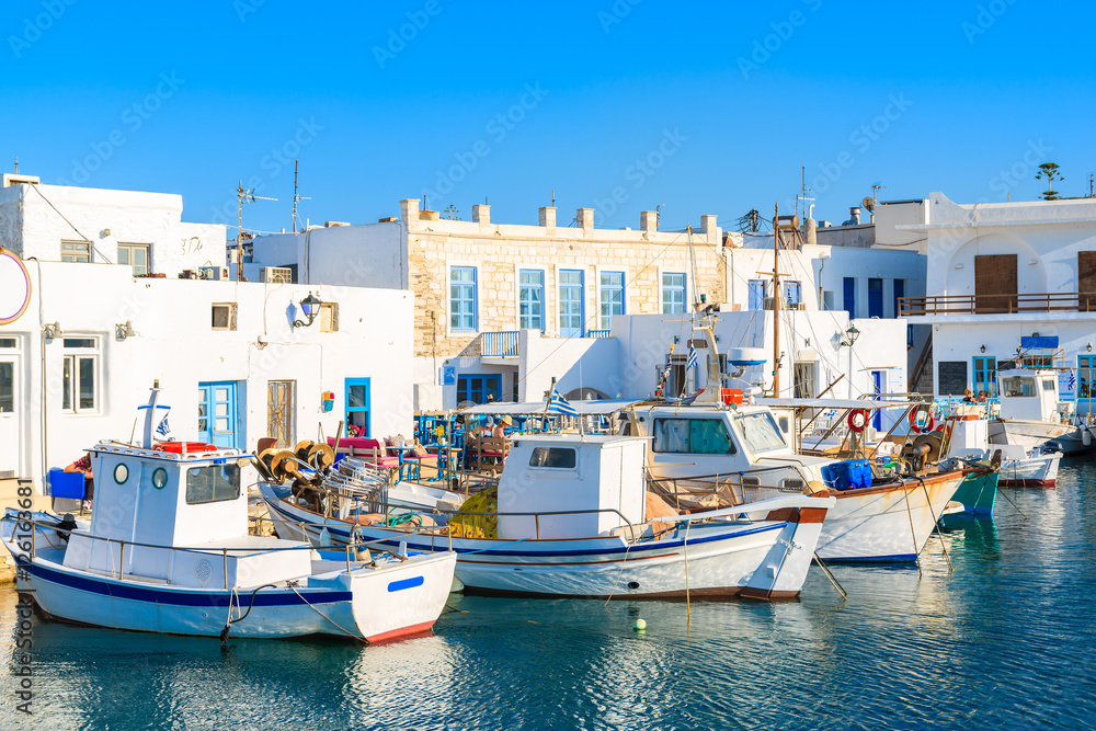 Traditional Greek fishing boats in Naoussa port at sunset time, Paros island, Greece