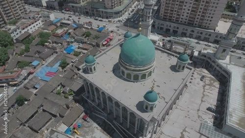 Slow aerial pan of a green domed mosque in central China photo