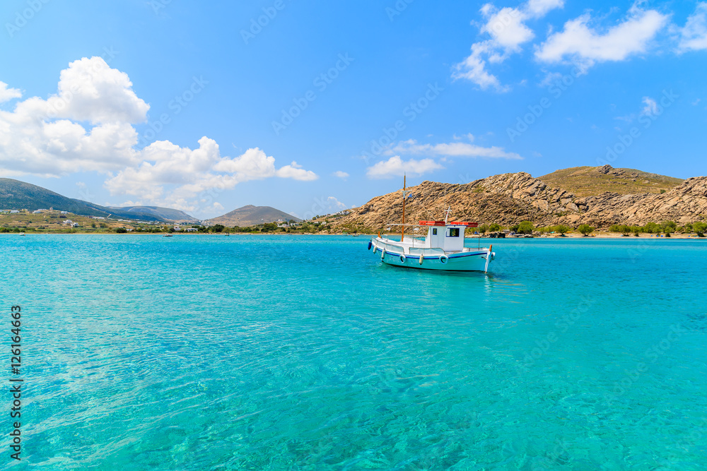 Typical Greek fishing boat sailing on turquouise sea water on Paros island, Greece