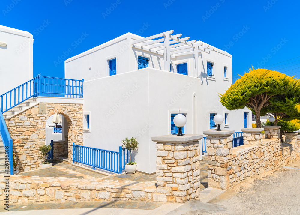 Street with traditional white Greek houses in Naoussa town, Paros island, Greece