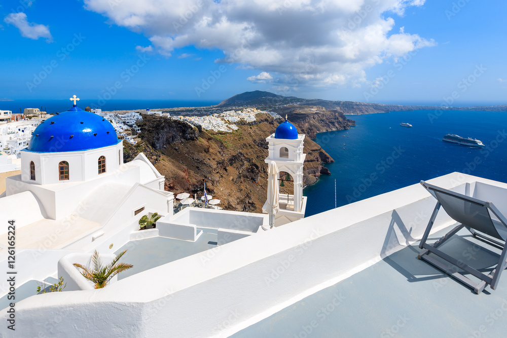 Fototapeta premium Blue dome of church in Imerovigli village and view of blue sea with caldera on Santorini island, Greece