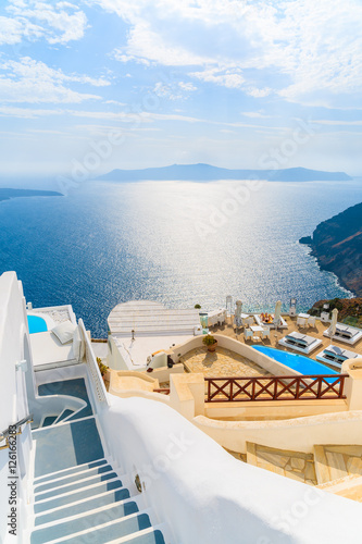 View of sea and and typical Greek boutique hotel with swimming pool in Imerovigli village, Santorini island, Greece © pkazmierczak