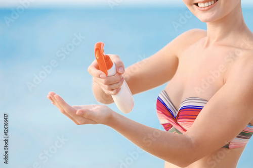 Young woman holding sun pro...