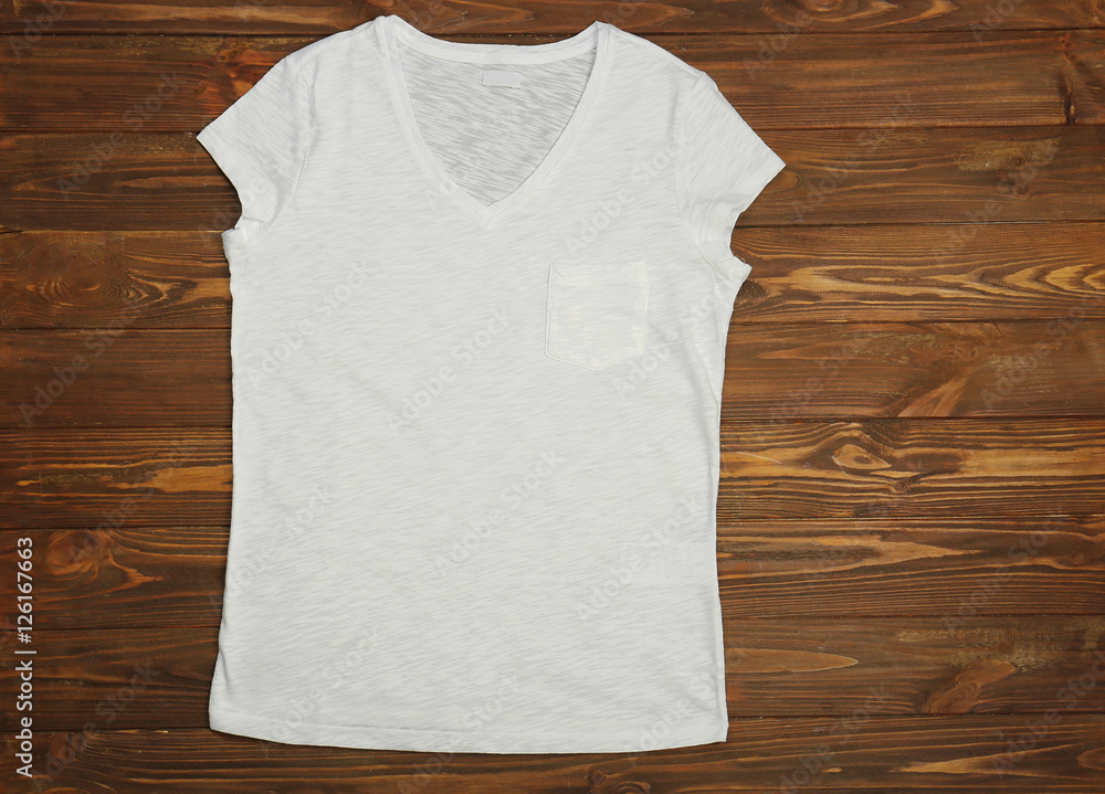 Blank white t-shirt on wooden background Blank white t-shirt on wooden background