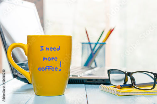 Slika na platnu I need more coffee written on big yellow cup with hot drink at home or business