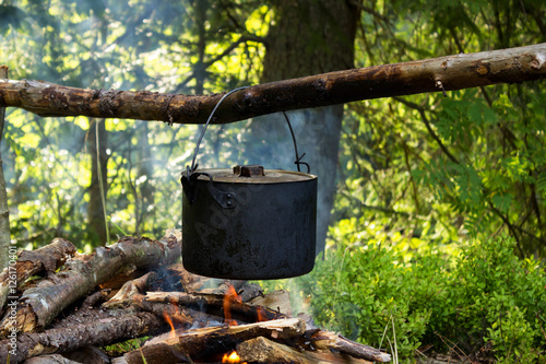 Pan on the fire. Cooking in a pot on the nature. Smoke and fire.