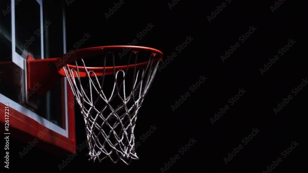 Close up of a basketball falling through the net of the hoop for a swoosh Close up of a basketball falling through the net of the hoop for a swoosh