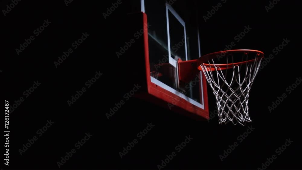 Close up of a basketball falling through the net of the hoop for a swoosh Close up of a basketball falling through the net of the hoop for a swoosh