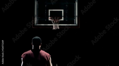 Medium shot of a basketball player shooting the ball